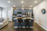 Here you can see the pantry located just off the kitchen and there is also a powder room tucked in there.