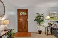 Entry into the living room. Nice solid beautiful wood door.