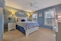 This ensuite bedroom is big and features a walk-in closet and new carpet.