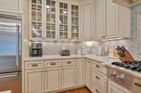 Okay I can't wait for you to see this magnificent kitchen!  Note the custom cabinets that reach right up the ceiling for maximum storage. You also get glimpses of the Viking gas cooktop and the Viking stainless refrigerator.