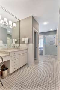 There are two long vanity areas both topped with Silestone quartz.  This vanity has a makeup niche