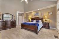 Primary bedroom has a soaring ceiling  and door to the covered porch.