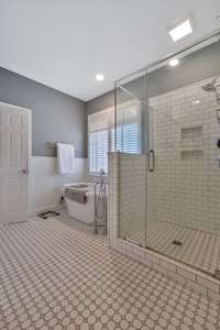 Oh Wow!  Did I mention that the primary bath is all new with custom tile floor and shower and a freestanding tub.