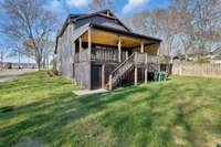 Cleverly designed to combine aesthetic features with practical applications, the newly installed secure carport below the back porch is large enough for 4 automobiles parked in tandem. Also note the home’s fresh exterior paint finishes.