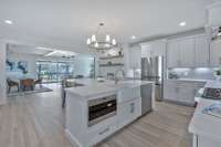 Built with room to breathe & move, this is a kitchen where one can finally enjoy cooking again. Washed in light thanks to recessed can LED lights & a chandelier, the kitchen features ample cabinet & cupboard storage & plenty of counter space.