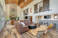 The real wood fireplace accentuates this space perfectly and contrasts nicely against the engineered wood floors and cedar-plank ceiling.