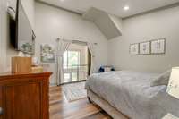 The guest bedrooms overlook the expansive great room below.  For privacy, there are double sliding barn doors when needed.