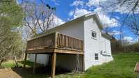 The large deck on the rear of the home overlooks the land which is bordered by to year-round creeks.