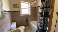 The full bath has a window which overlooks the rear of the property.