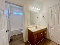 Large bath between 2 bedrooms; split floor plan; tub/shower combo; hardwood , carpet and tile flooring