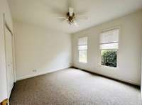 Large bedroom with carpet, large closet and ceiling fan