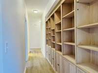 Built in bookcases in hallway; Split floor plan hardwood floors, carpet and tile floor coverings