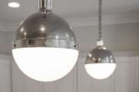 Custom lighting such as these modern style pendants are throughout the home enhancing every room!