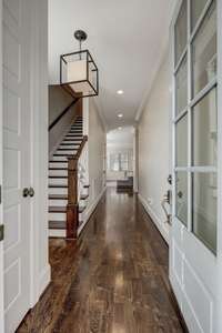 Welcome Home! Neutral paint tones compliment the gleaming hardwood floors right as you enter. The foyer welcomes you directly to the casually elegant living and kitchen areas.