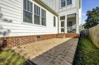 A basketwoven paver patio provides additional entertaining space off the screened in porch located in the private side lawn.