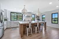 Designer Kitchen with beautiful white oak colored flooring and picture windows