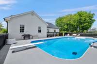 Diving Board, Pool, large patio and back of white painted brick house