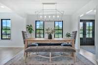 Open Concept Dining Area with luxury lighting and black Pella Windows to accent the views