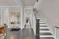 The foyer of the home where you can see beyond to the covered back deck and out to all of the green space