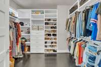 Primary closet with thoughtful built ins, plenty of hanging space, and built in drawers