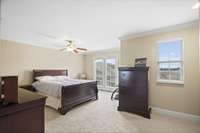 Huge primary suite with his and hers walk-in closets and Juliet balcony.