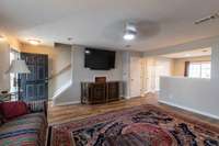 Living Room, with views of the kitchen. Half bathroom is the door next to the TV/Cabinet