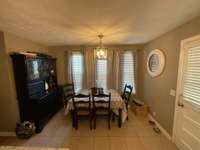 GENEROUS EAT-IN AREA OF KITCHEN ACCOMMODATES LARGE TABLE & CHINA CABINET.