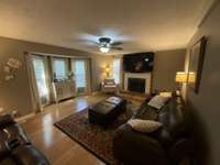 SPACIOUS LIVING ROOM WITH BAMBOO FLOORING.