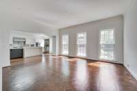 Large floor to ceiling windows cast light on this incredible inlaid wood floor shipped from France when the home was built. You may choose to use this beautiful room connected to the kitchen as a family room or dining room.