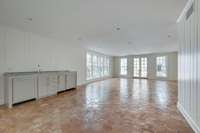 This is one stunning room when the light shines in on the handmade tile floor thru the banks of windows. Complete with a full bar with refrigerator and dishwasher, you can entertain inside and out.