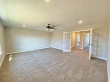 Large bonus room with closet and beautiful glass french doors (photo is of model home with same floor plan)