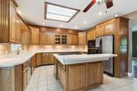 Another view of the kitchen featuring the double ovens and tile flooring.