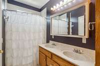 This bathroom also has double vanities and a shower/tub combo.