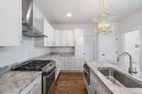 Gas range, quartz countertops, new lighting, tasteful finishes throughout.