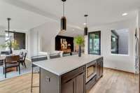 Kitchen is open to dining room and door leads to deck with stairs to a fenced yard space