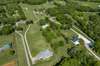 Aerial view from the back showing all of the mature trees