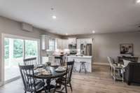 Here you can see the access to the covered back patio and how these homes back up to beautiful green space and mature trees.