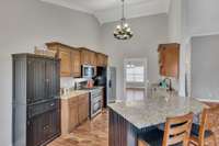 Kitchen with high ceiling and granite counters