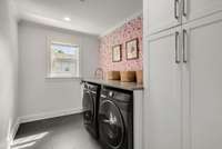 The most charming laundry room with ample storage.