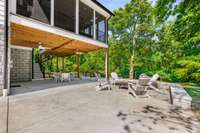 In addition to the attached 2 car garage, there is more carport space if so desired or use it for outdoor gathering as shown here.