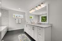 The spa-like primary bath with dual sinks and transom windows for wonderful light.