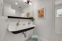 Upstairs hall bath with sharp penny tile and schoolhouse sink.