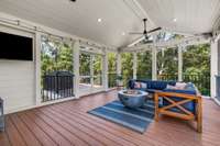 The screened back porch has TREX decking for ultimate low maintenance.