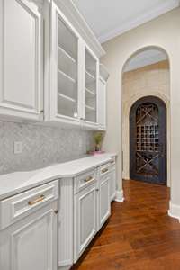 A convenient butler's pantry and wine cave right off of the kitchen