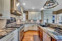 Spacious Cabinetry &Countertops under-counter lighting Designer Finishes