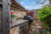 An outdoor kitchen w Grill and Smoker