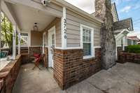 Here you can see there is a covered porch area and also an uncovered area. This is just one of the many outdoor spaces this home has to offer.