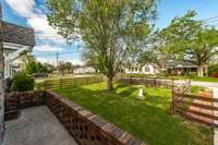 There is a wraparound porch overlooking the front yard.