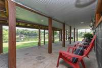 covered deck, walks out to the lake and boat dock