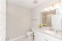 Secondary full bath with soaking tub with new glass doors and tile surround.